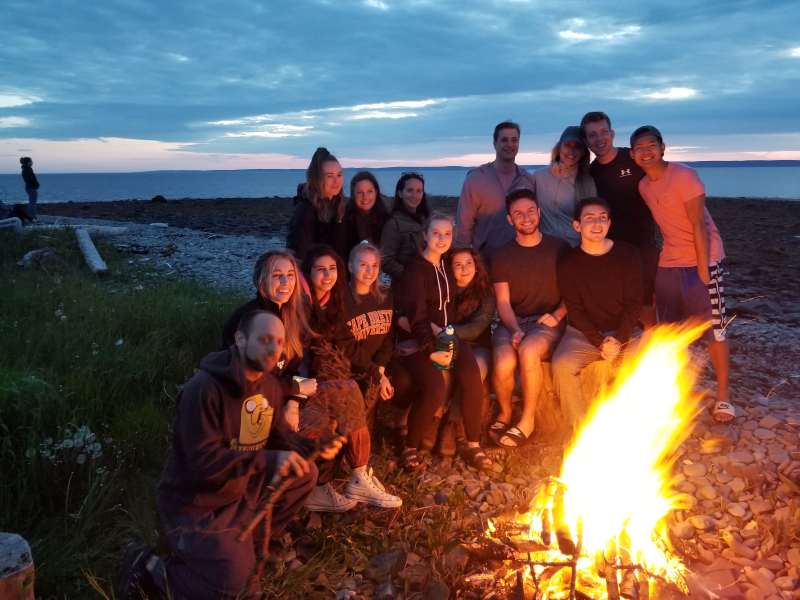People around a fire who received high school scholarships to study French
