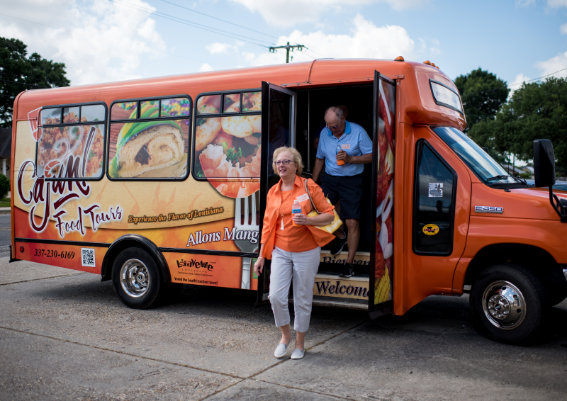 Two people on the Cajun Food Tours bus